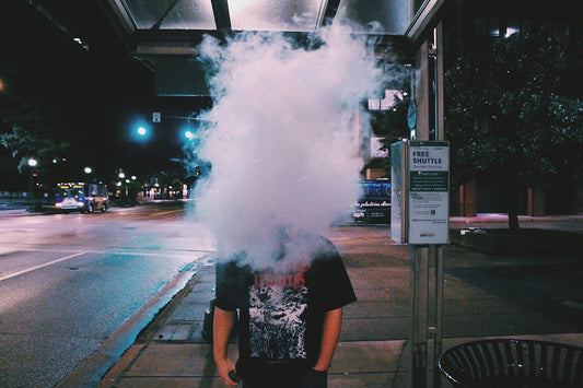 man blowing smoke