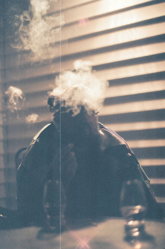 man in black jacket smoking