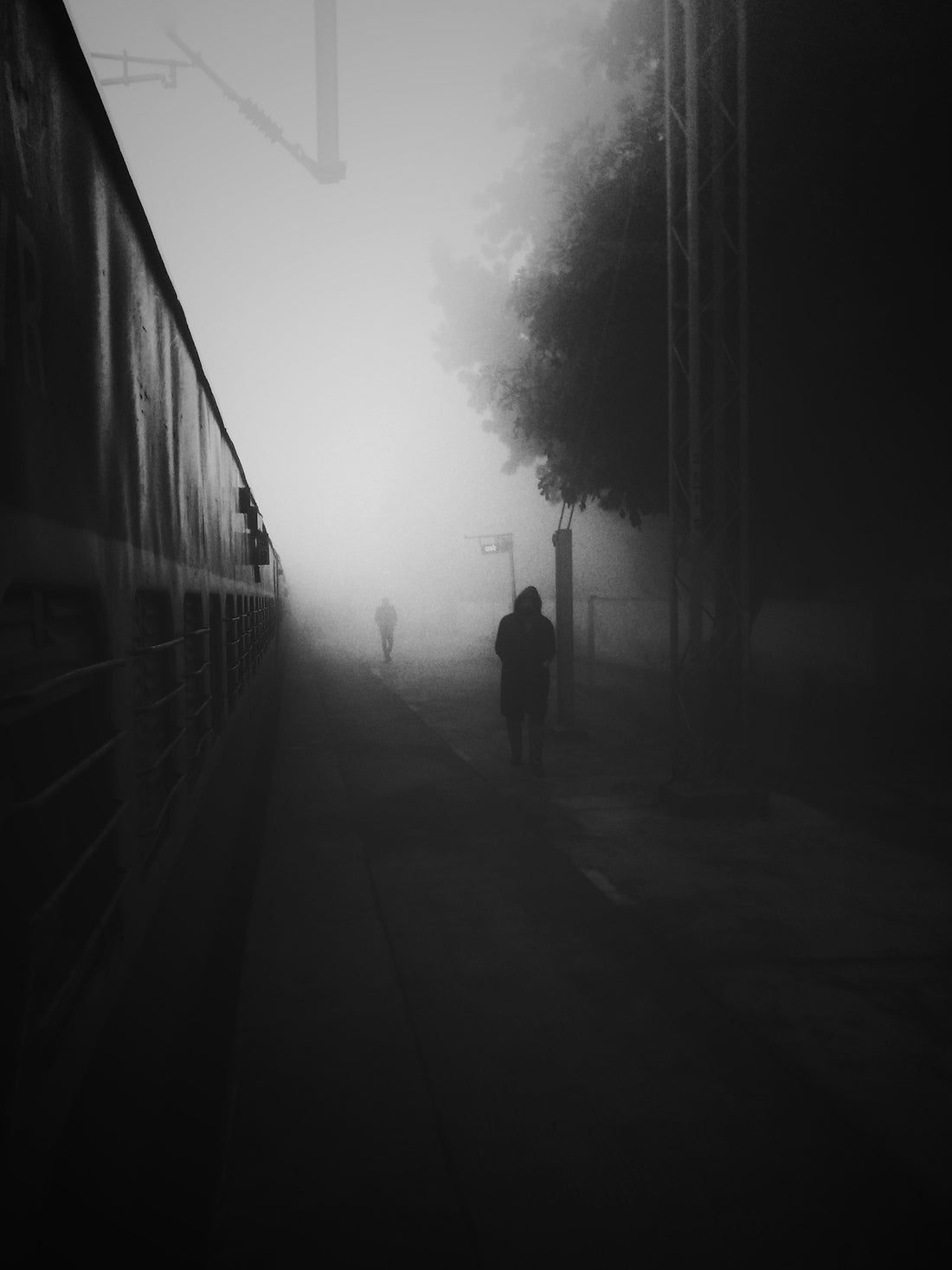 grayscale photo of 2 person walking on pathway