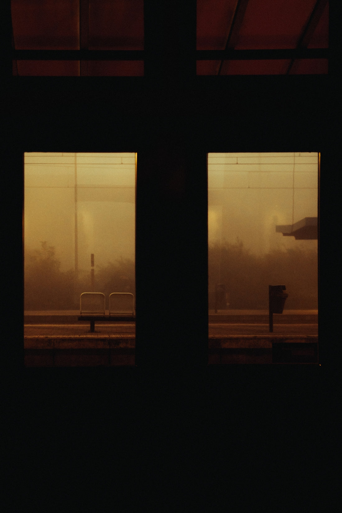a view of a train station through two windows