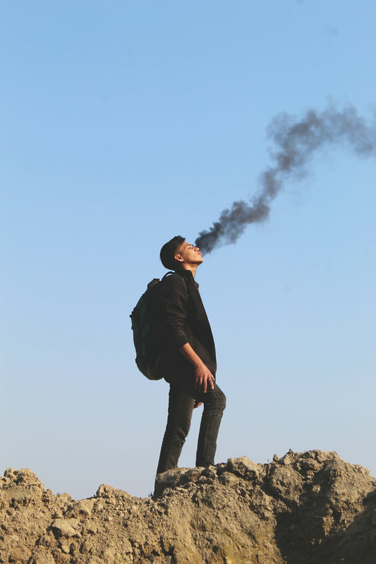 a man standing on top of a rocky hill