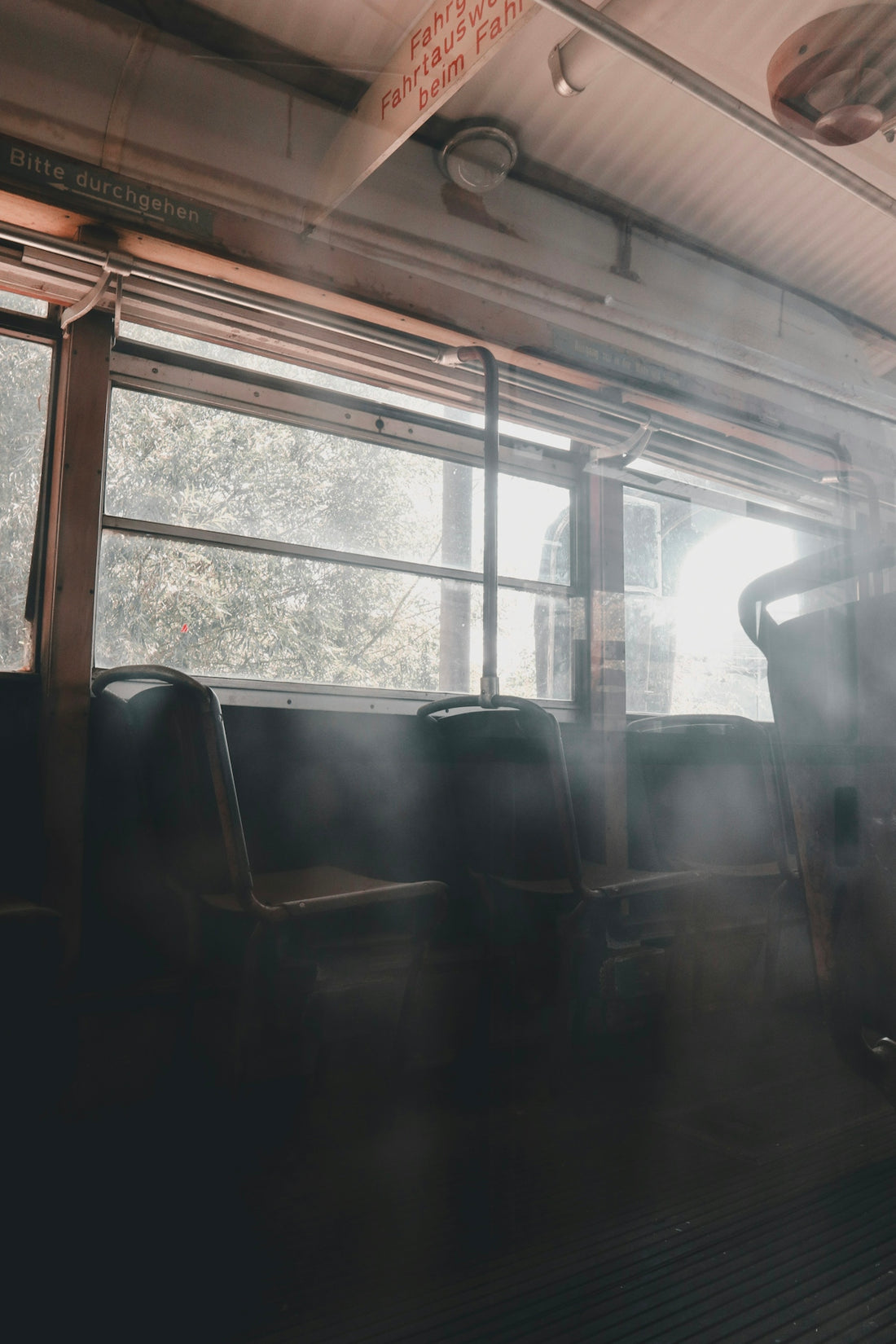 A train car filled with lots of seats next to a window