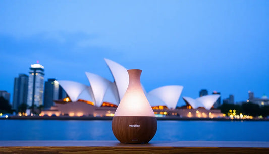Sydney Raumduft Diffuser with elegant wood finish glowing at dusk near Sydney Opera House, creating a relaxing home ambiance with fresh pear, rose, and bergamot scents.